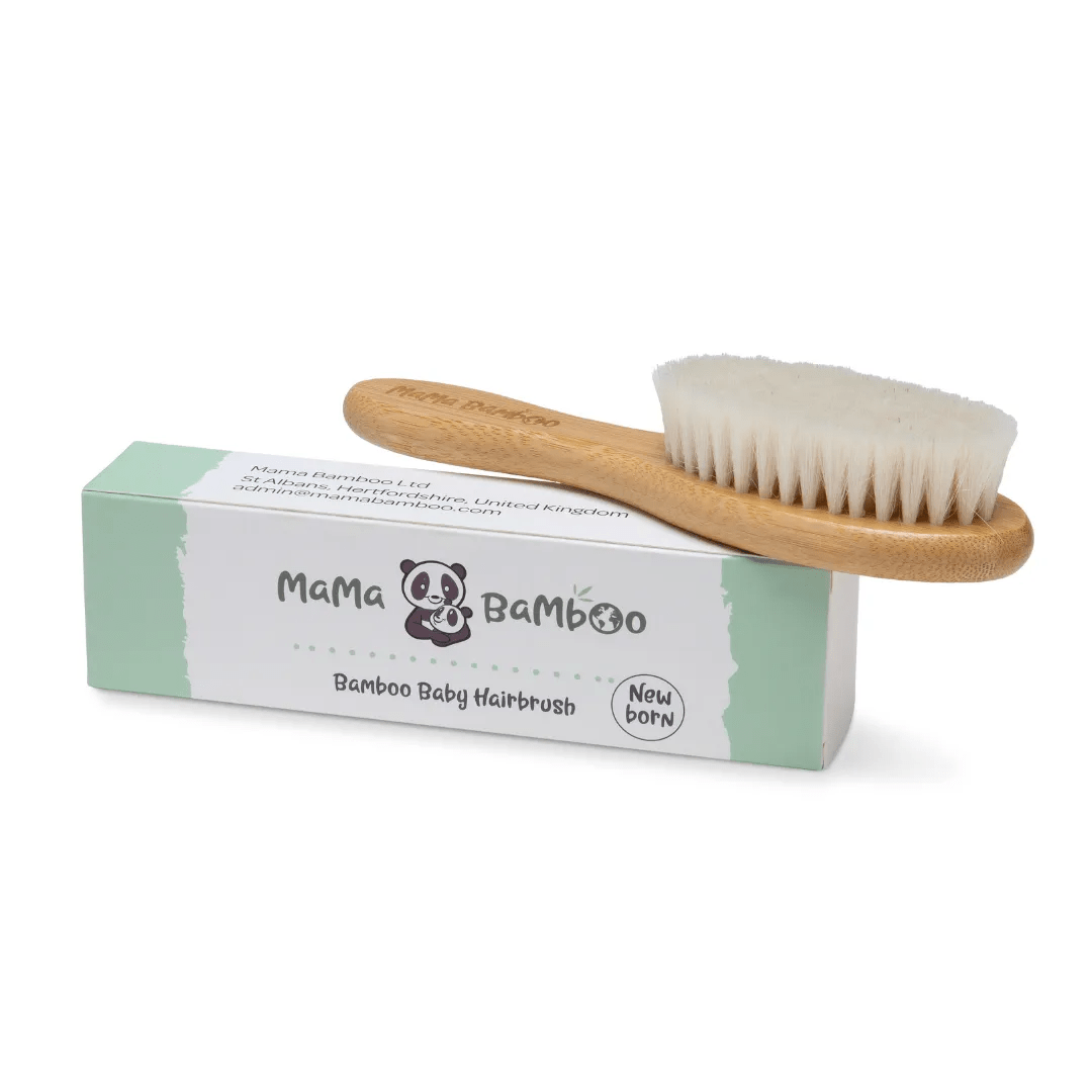 Mama Bamboo baby hairbrush with a bamboo handle and pale goat-hair bristles resting on its cardboard box