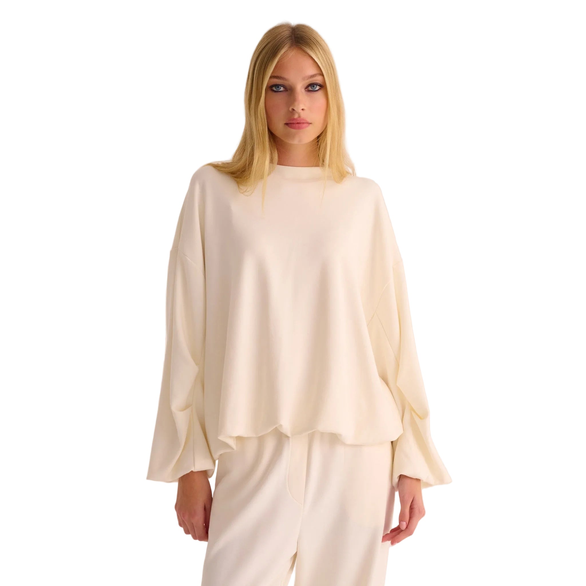 Woman wearing a cream-colored outfit on a white background
