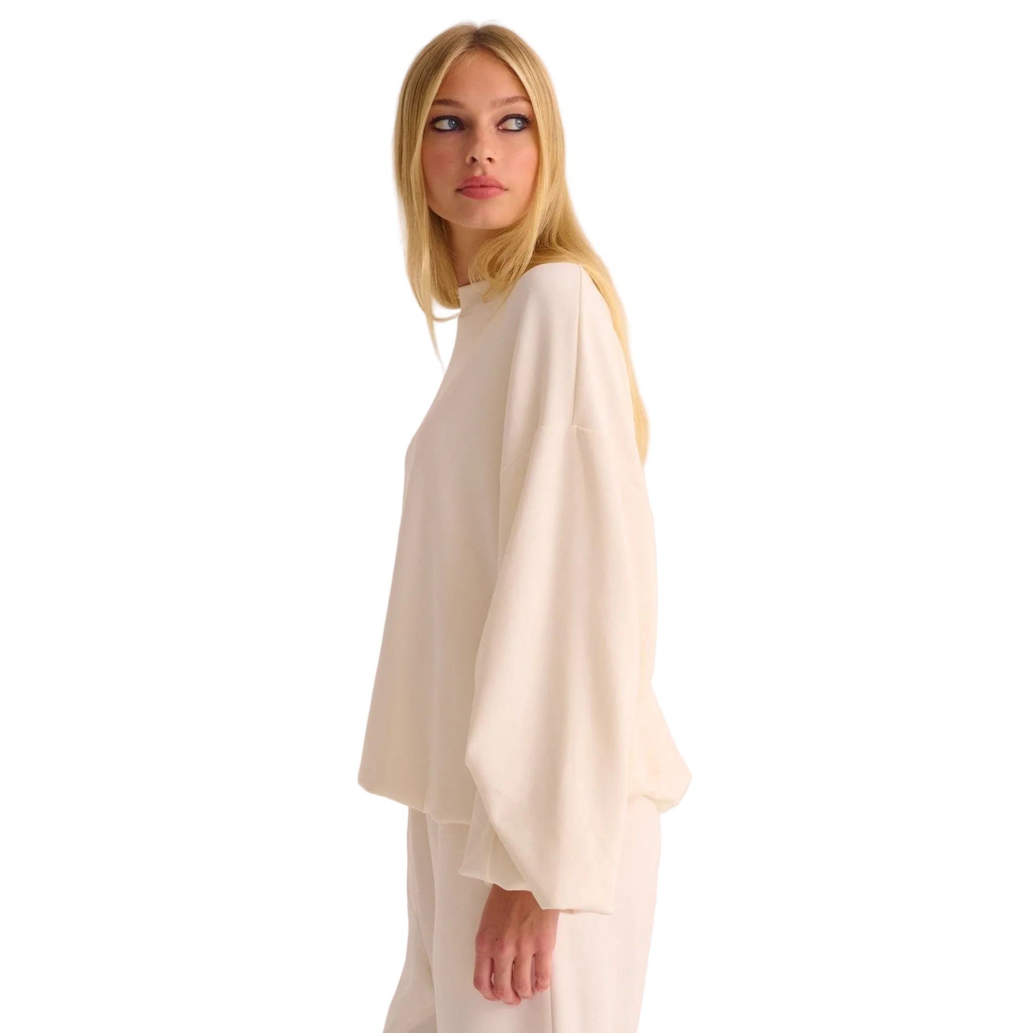 Woman wearing a white outfit against a plain background