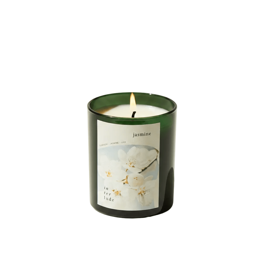 Candle with a label featuring floral design on a white background
