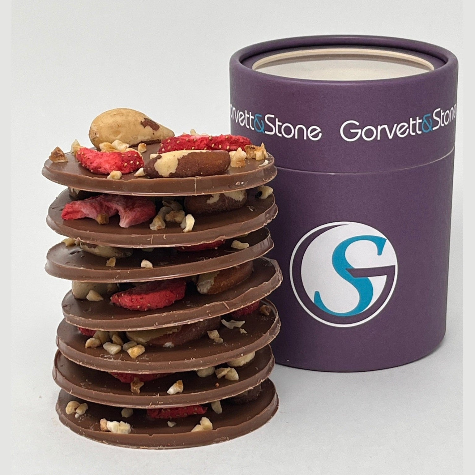 Stack of chocolate-covered treats with a purple Gorvet Stone branded container on a white background