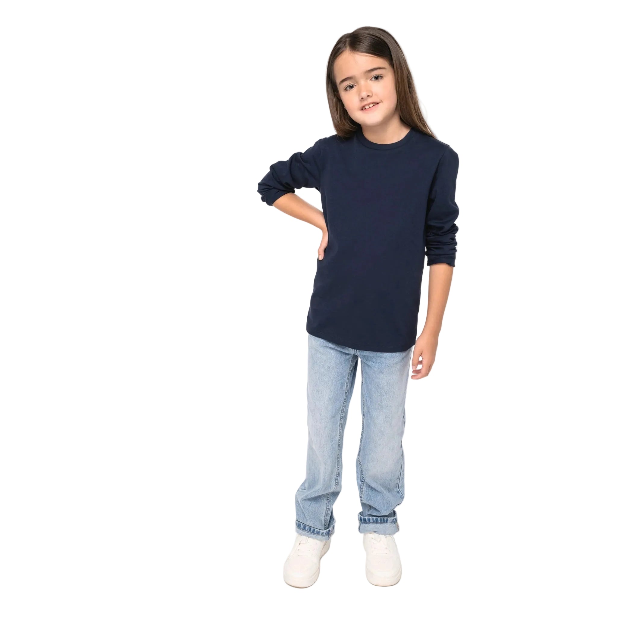 Young girl wearing a navy blue long-sleeve shirt and light blue jeans on a white background