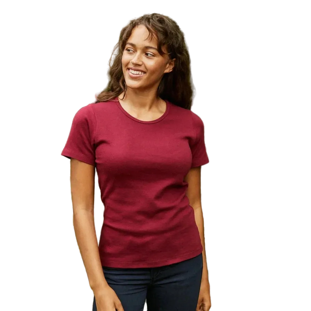 A woman wearing a short-sleeve crewneck t-shirt in a solid deep burgundy color, paired with dark blue jeans, shown against a plain white background.