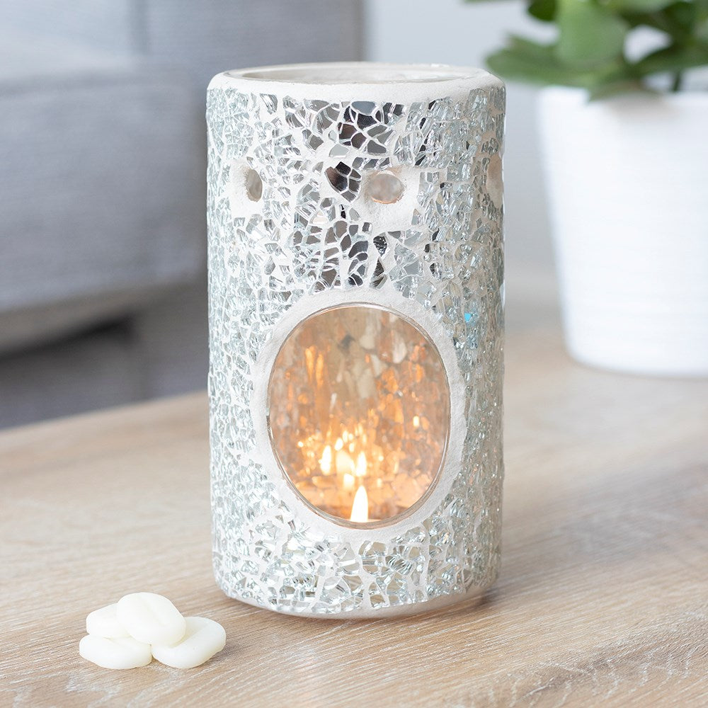 Decorative candle holder with mosaic pattern on a wooden surface