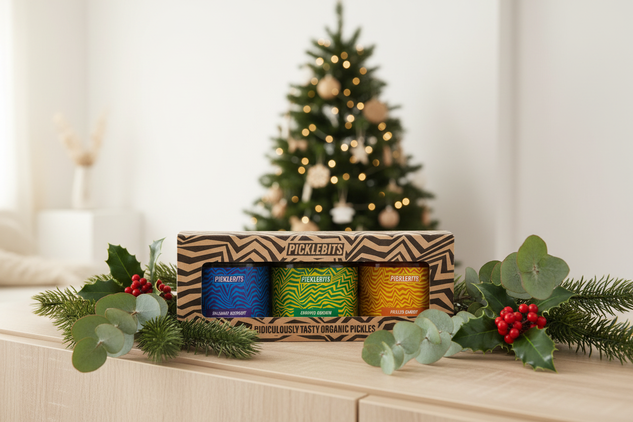 Box of Picklebits with a Christmas tree and decorations in the background