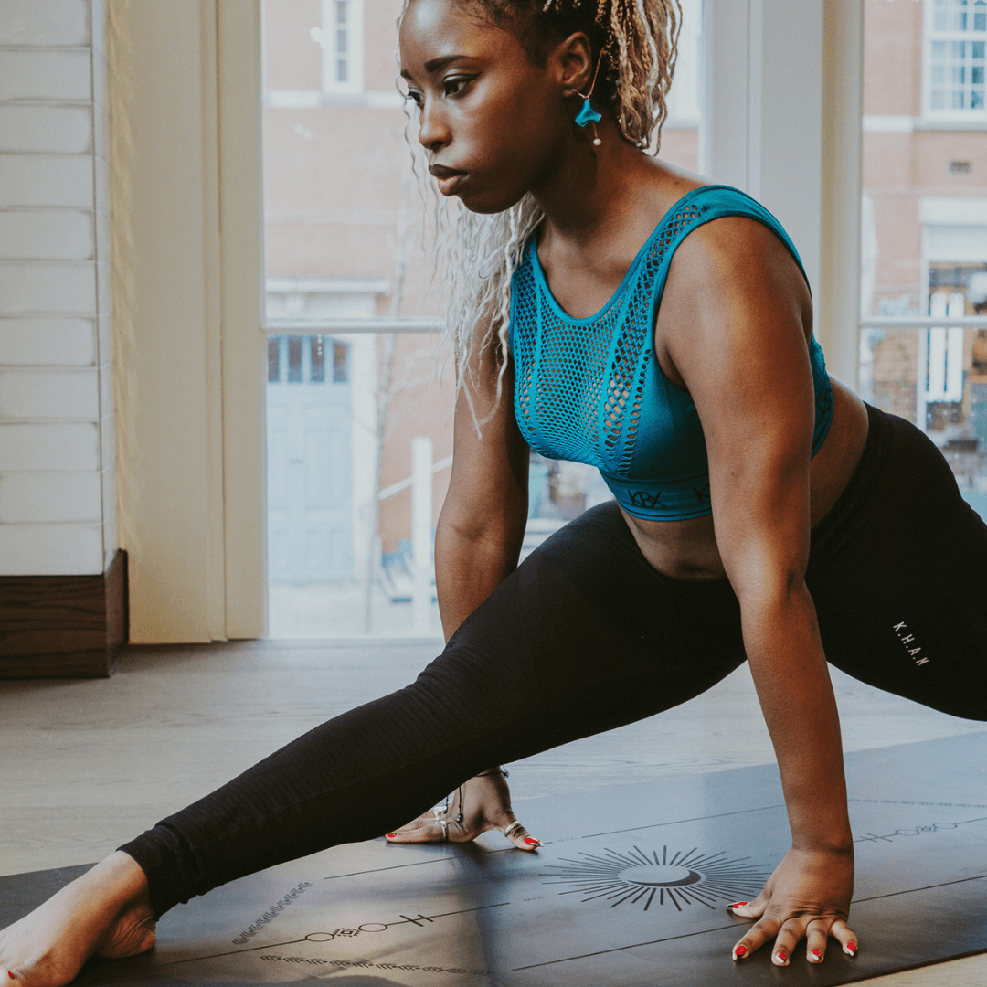 Woman in a yoga pose on a mat indoors