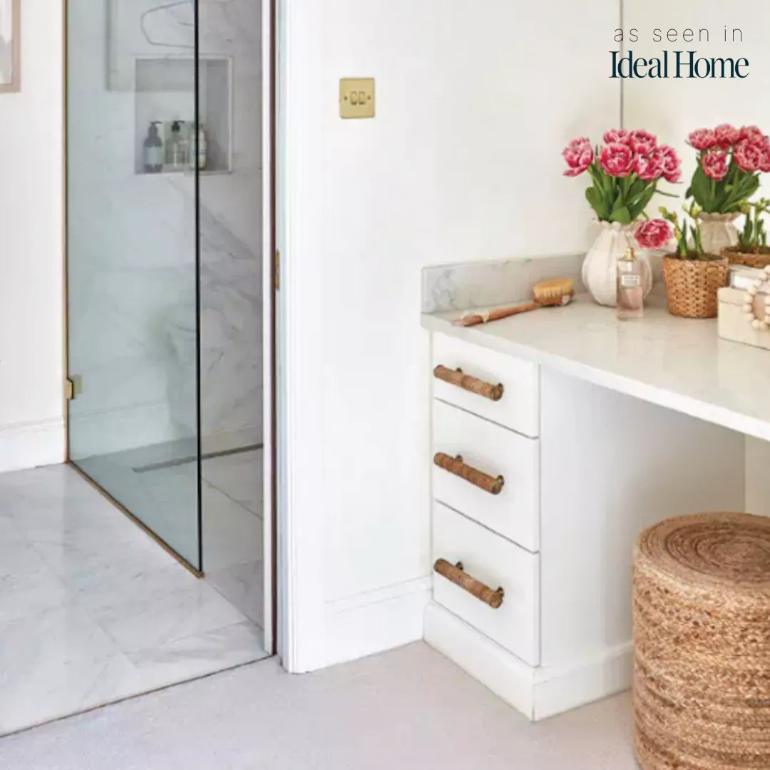 Dunstanburgh rattan bar handles fitted horizontally to white bathroom drawers