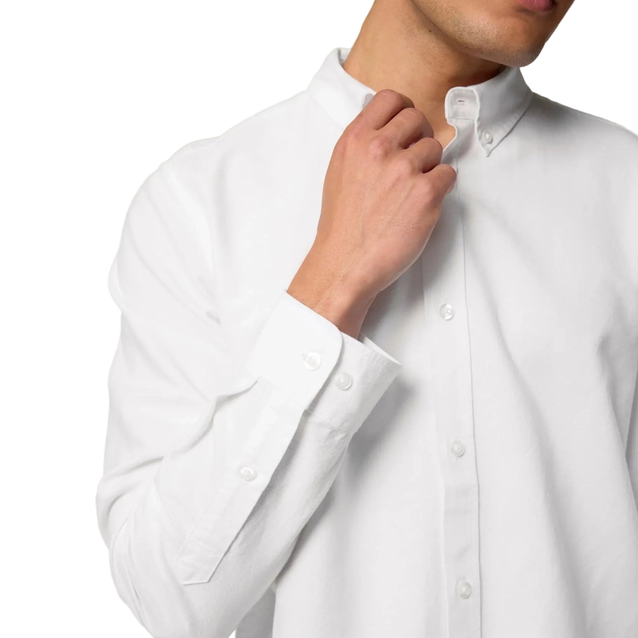 White dress shirt with a close-up of a hand adjusting the collar on a white background