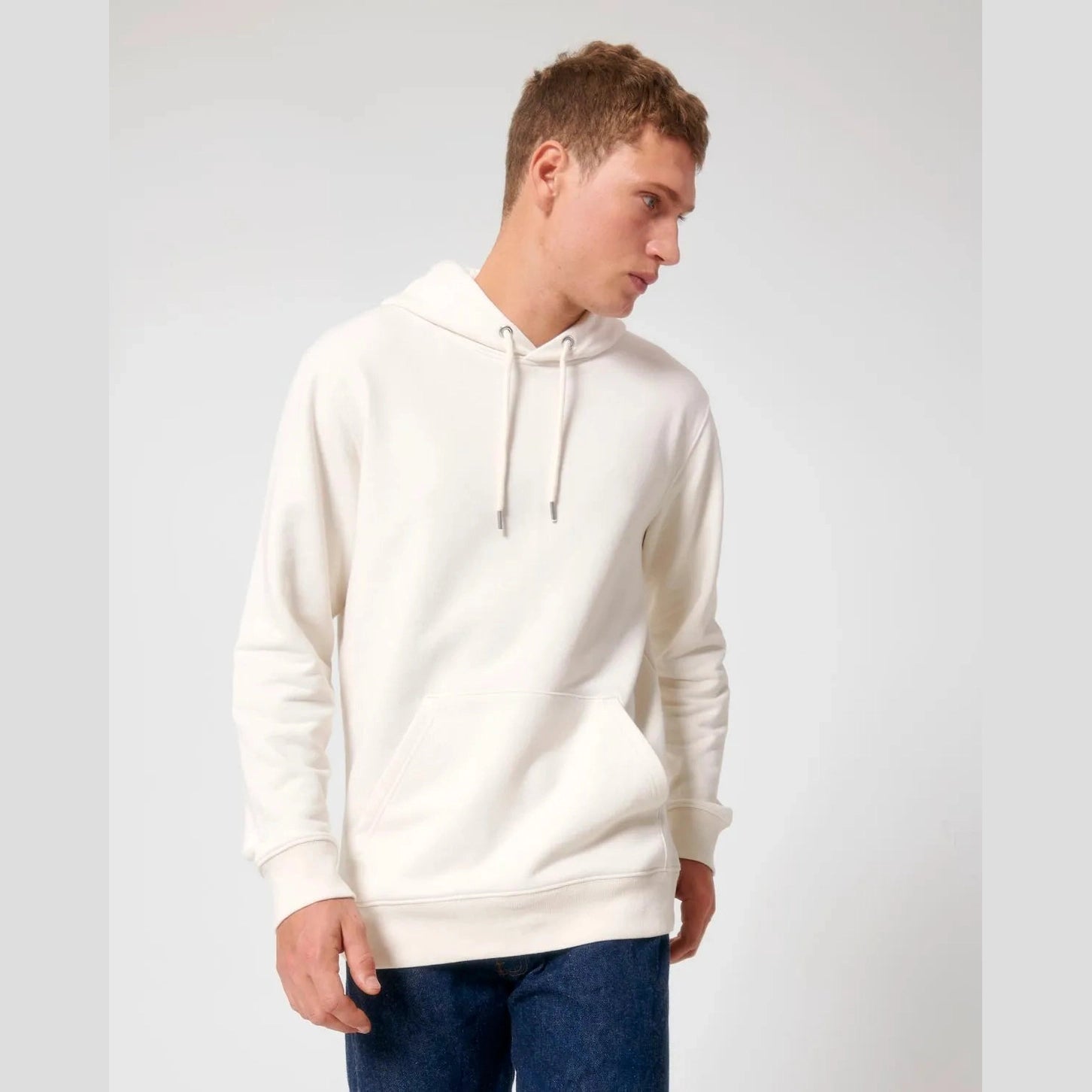 Man wearing a white hoodie on a light grey background
