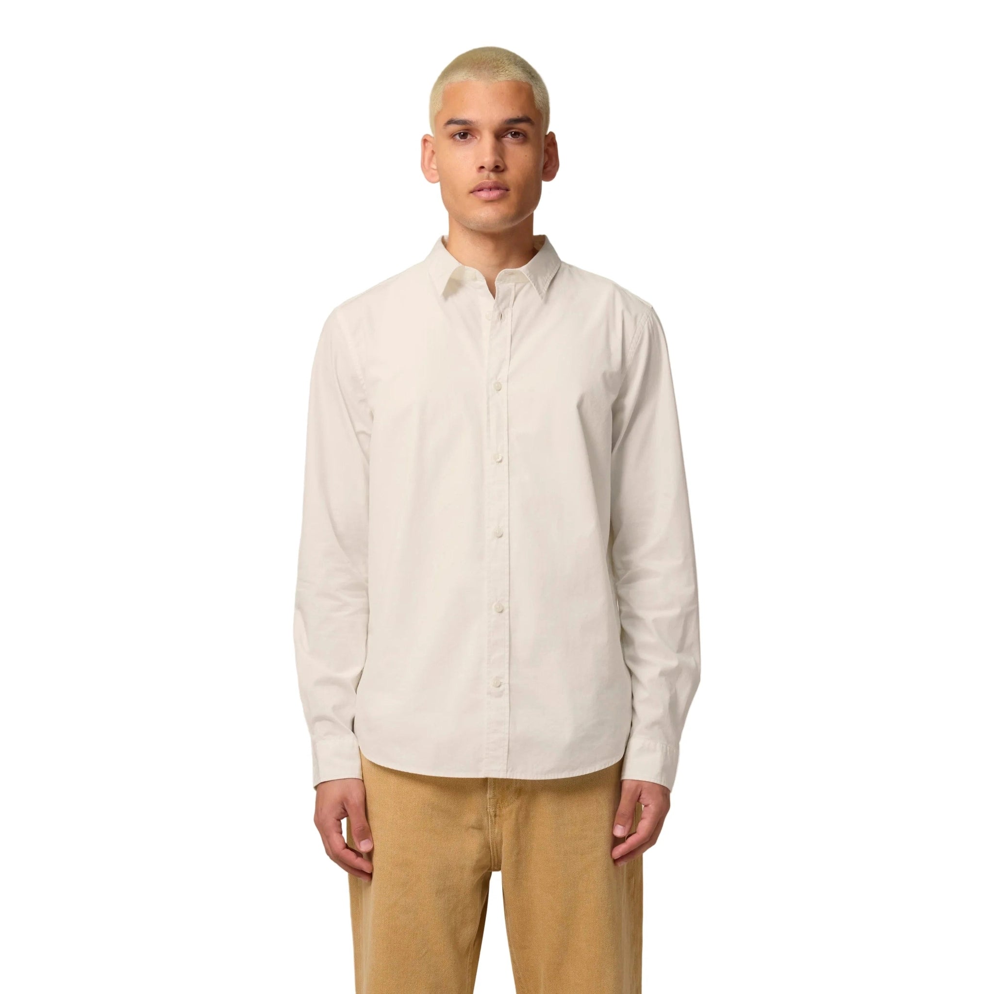 Man wearing a beige button-up shirt and beige pants on a white background
