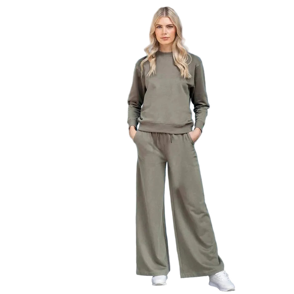 Woman wearing a green tracksuit on a white background