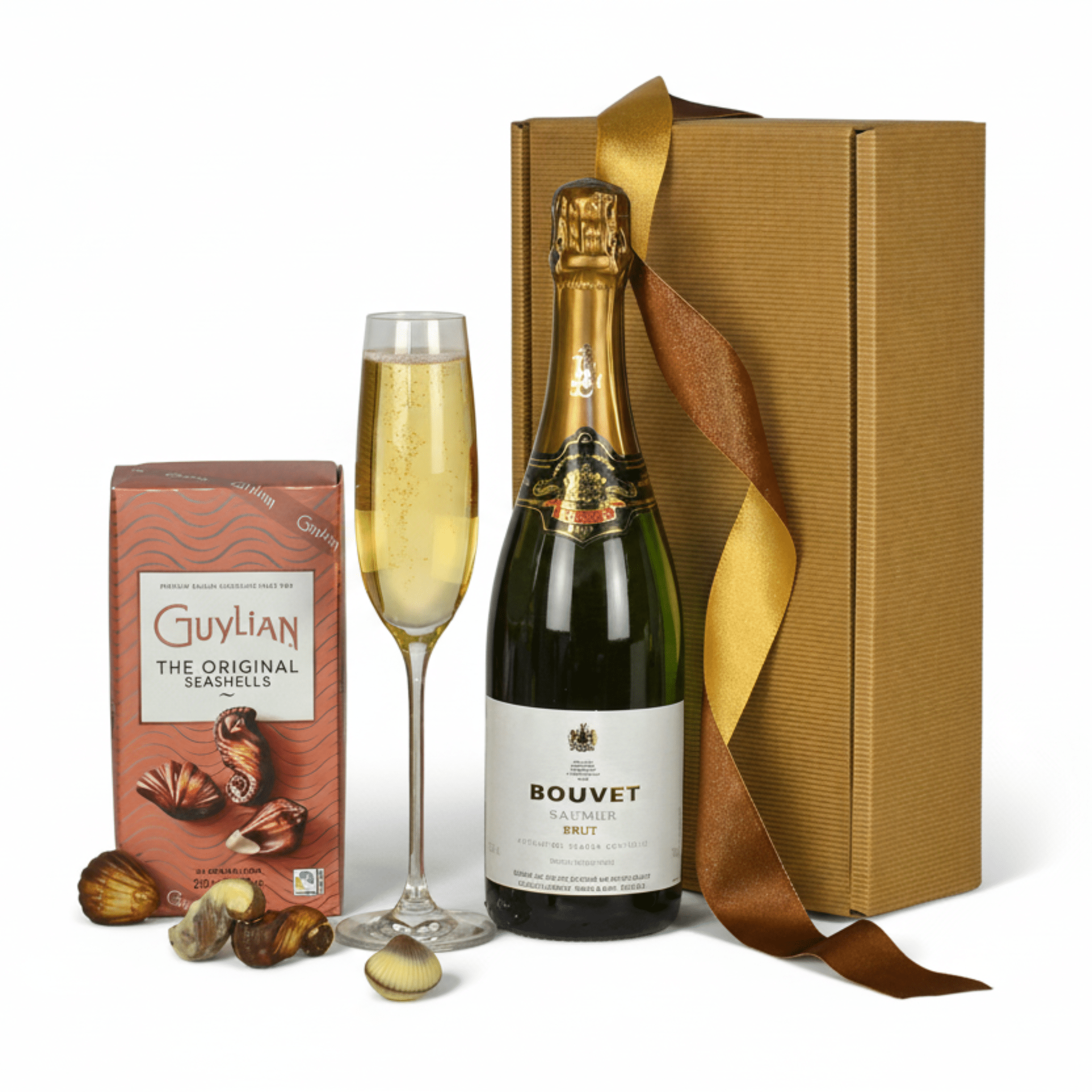 Bottle of Bouvet sparkling wine, glass, box, and chocolate seashells on a white background