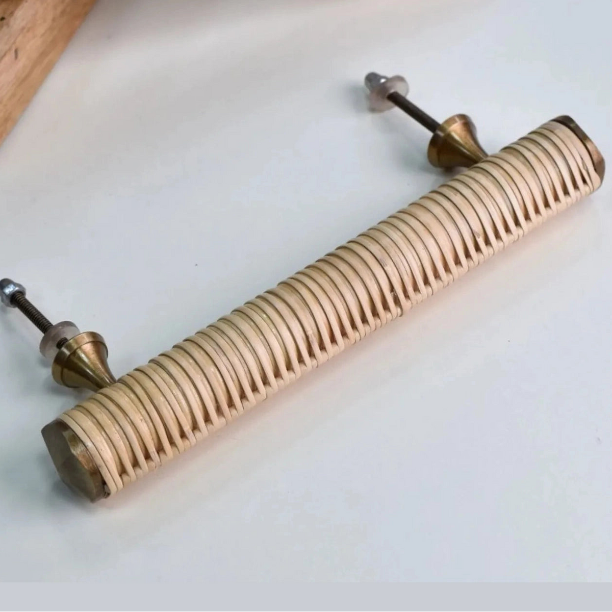 Rear view of a Druridge rattan bar handle with two projecting fixing bolts