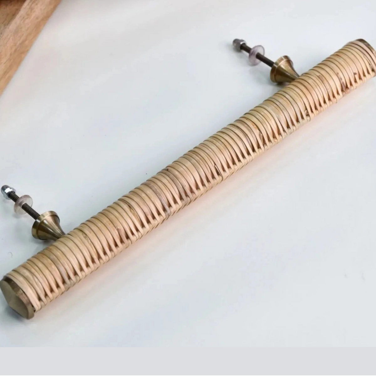 Rear view of a long Druridge rattan bar handle showing two fixing bolts and metal mounts