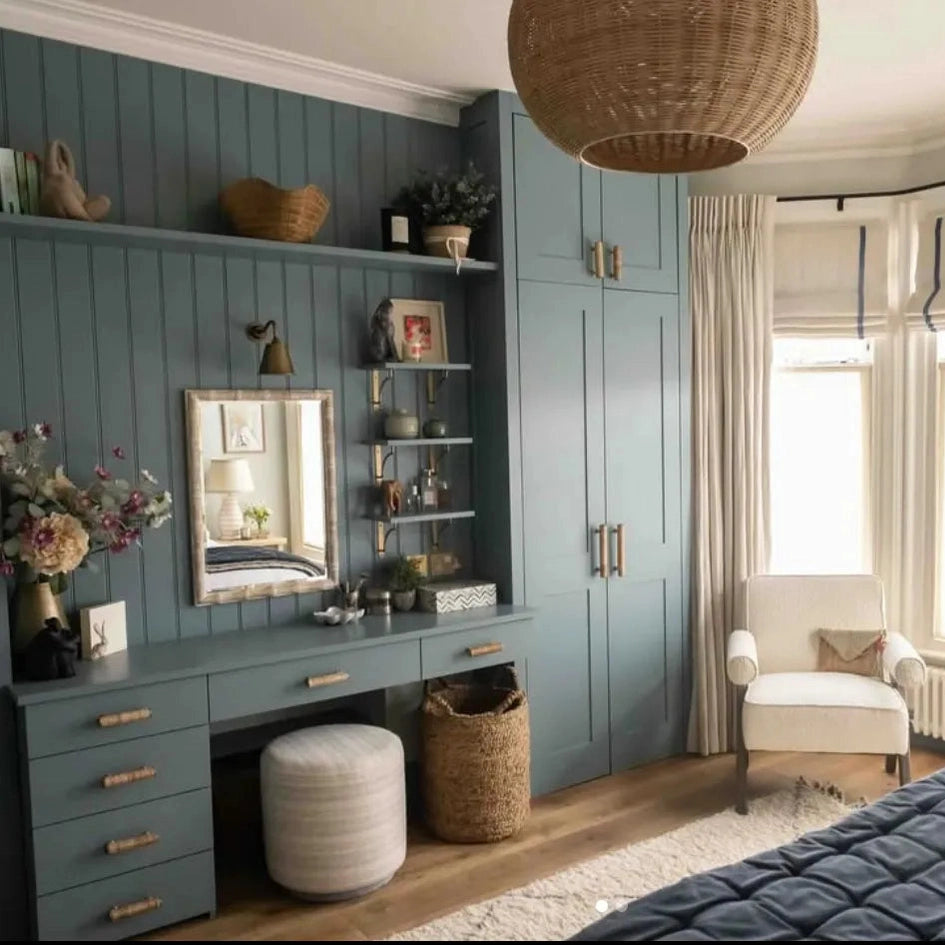 Dunstanburgh rattan handles on blue fitted wardrobes and dressing-table drawers