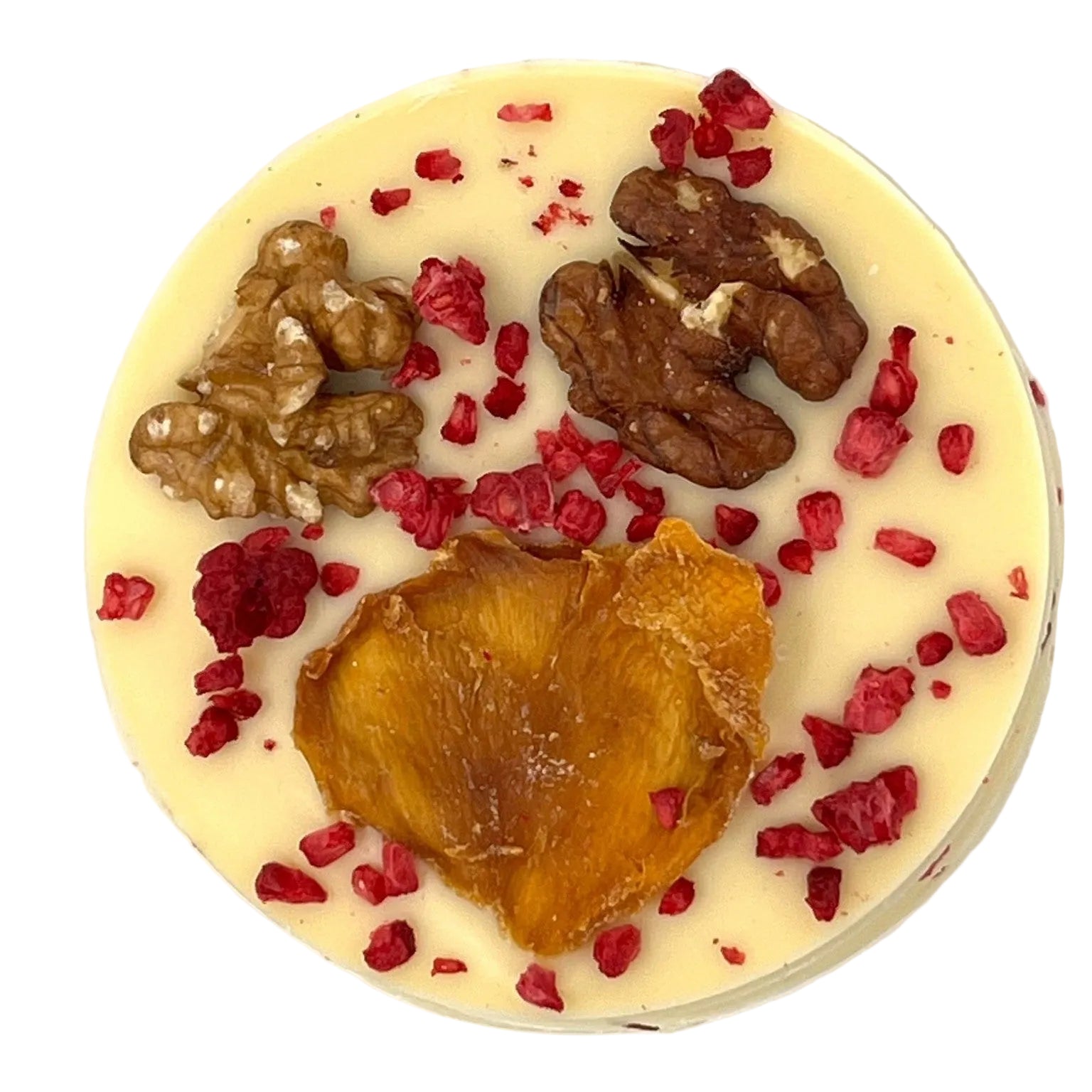 Round white chocolate disc with white chocolate, dried fruit, and nuts on a white background