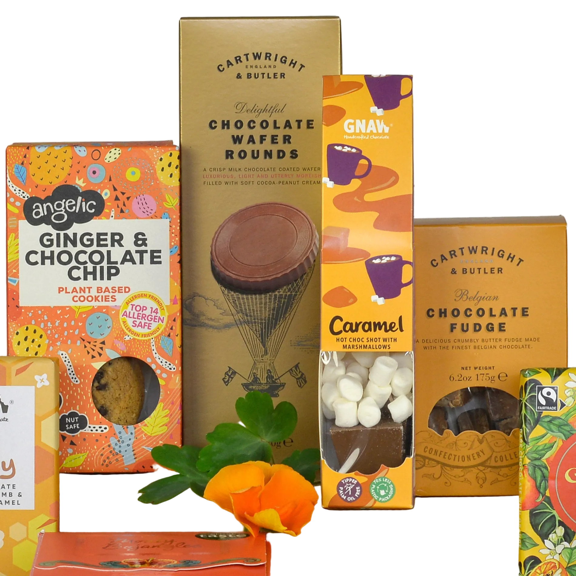 A group of packaged sustainable chocolate and cookie products arranged together on a white background, including Cartwright & Butler chocolate wafer rounds, Belgian chocolate fudge, and Angehic ginger and chocolate chip cookies, with a chocolate bar and small orange flower in front.