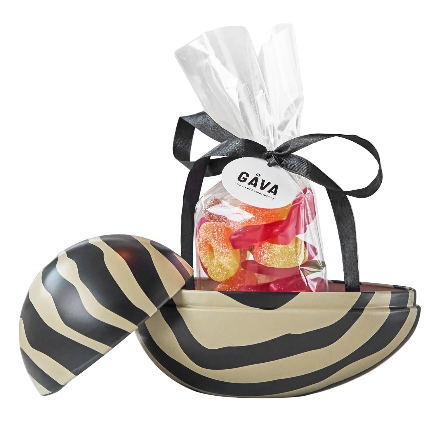 A bag of sweets with a black and beige striped Easter egg on a white background