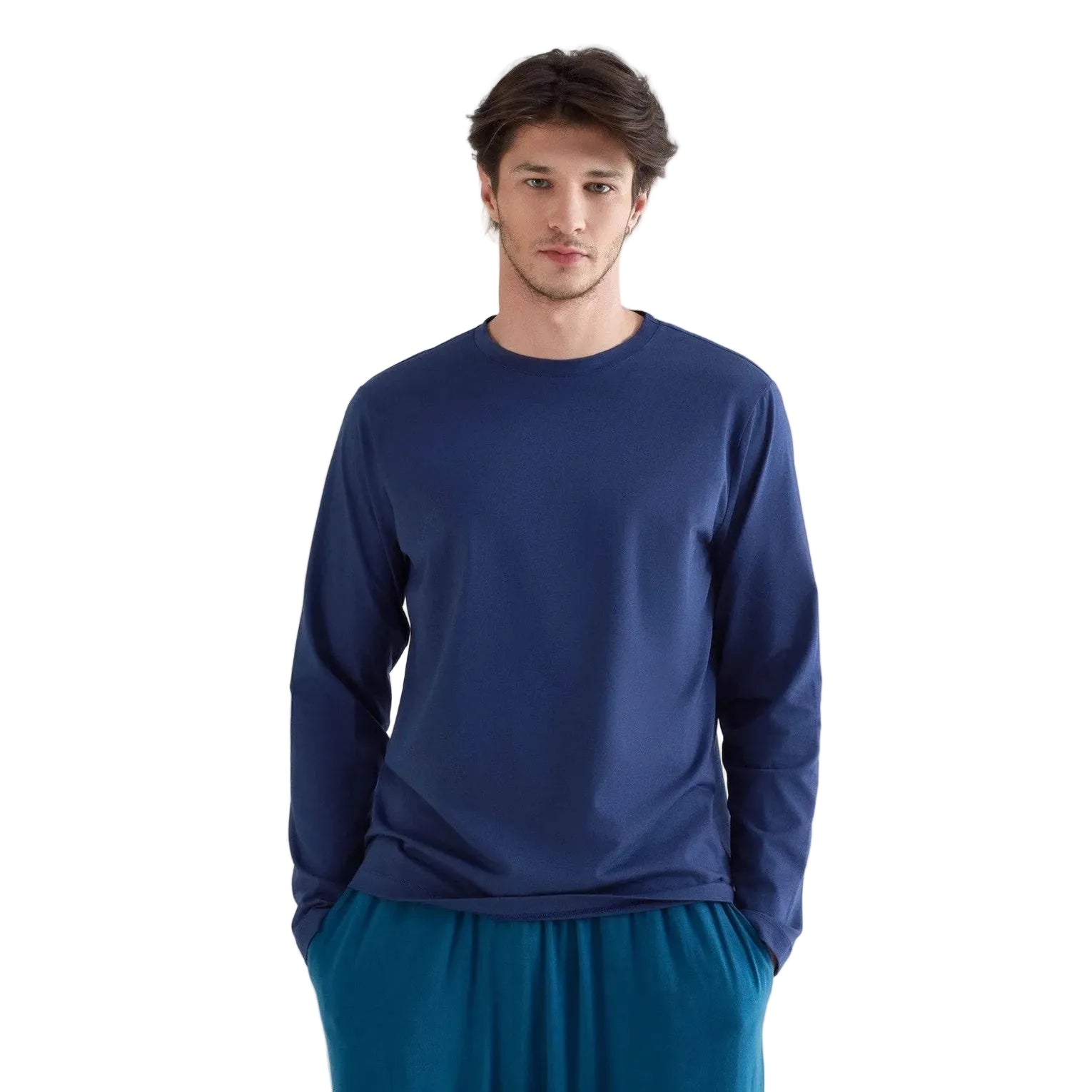 Man wearing a blue long-sleeve shirt and blue pants on a white background