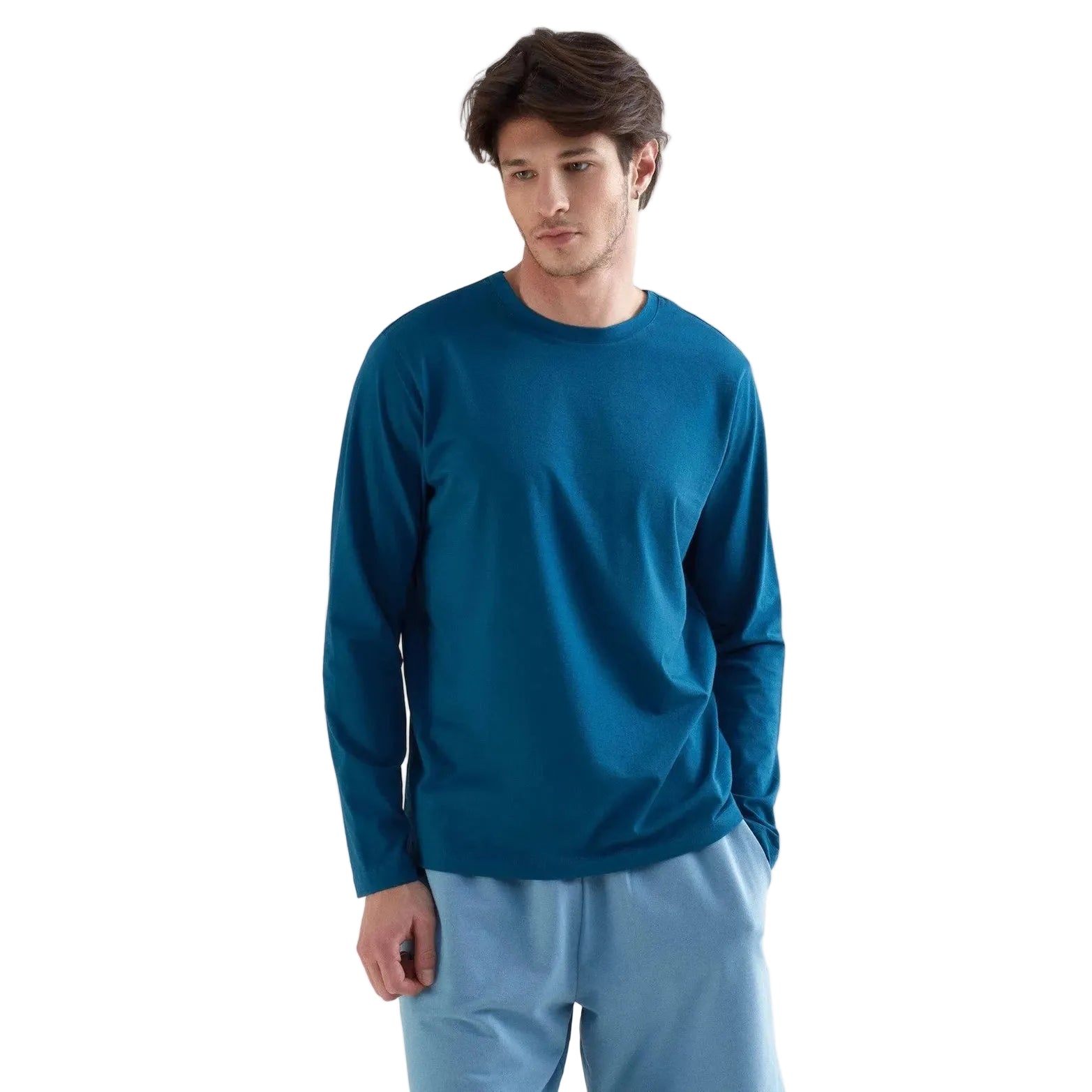Man wearing a blue long-sleeve shirt and light blue pants on a white background