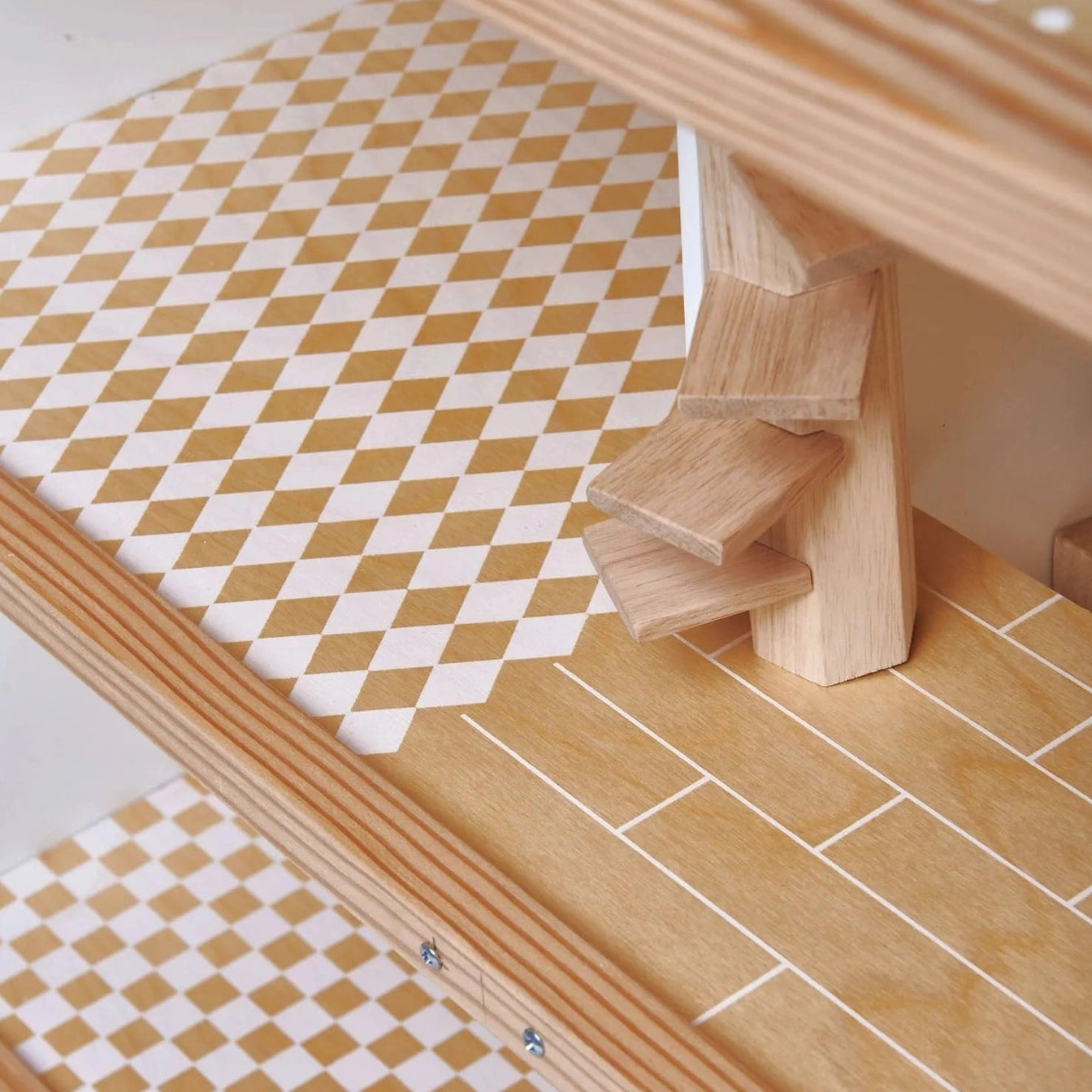 Close-up of a wooden staircase with light natural wood steps and a geometric patterned carpet in beige and white.