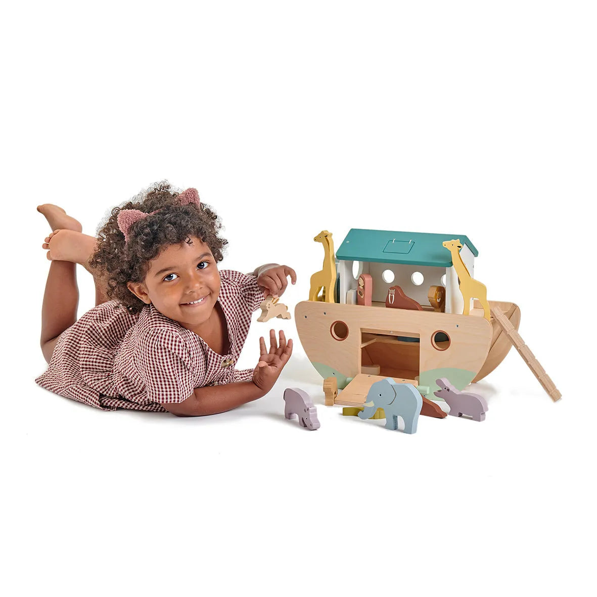 Child playing with a wooden toy Noah's Ark on a white background