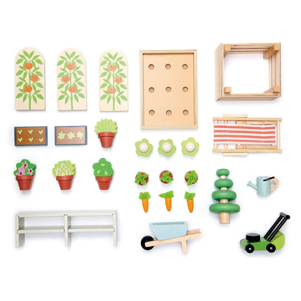 Tender Leaf miniature garden accessories laid out on white, including vegetables, plants, seed trays and gardening equipment