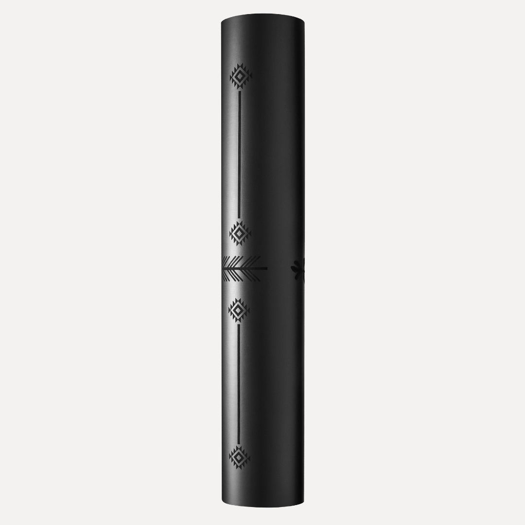 Black rolled-up yoga mat with decorative patterns on a white background