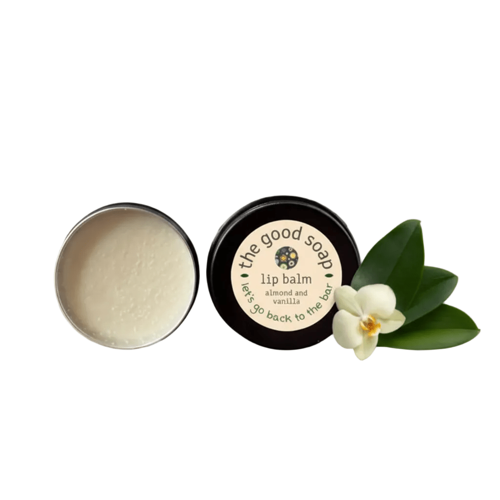 Lip balm container with a white flower and green leaves on a white background