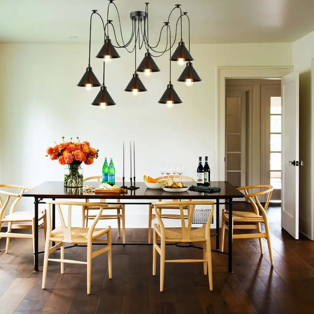Dining room with a black table, wooden chairs, and a chandelier.