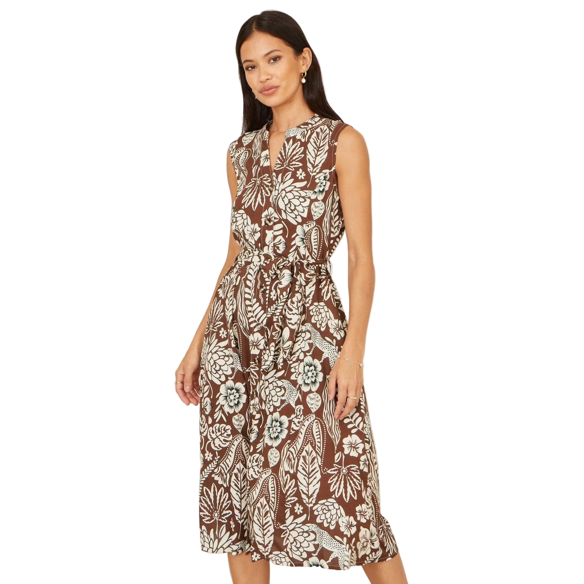 Woman wearing a brown floral dress on a plain background