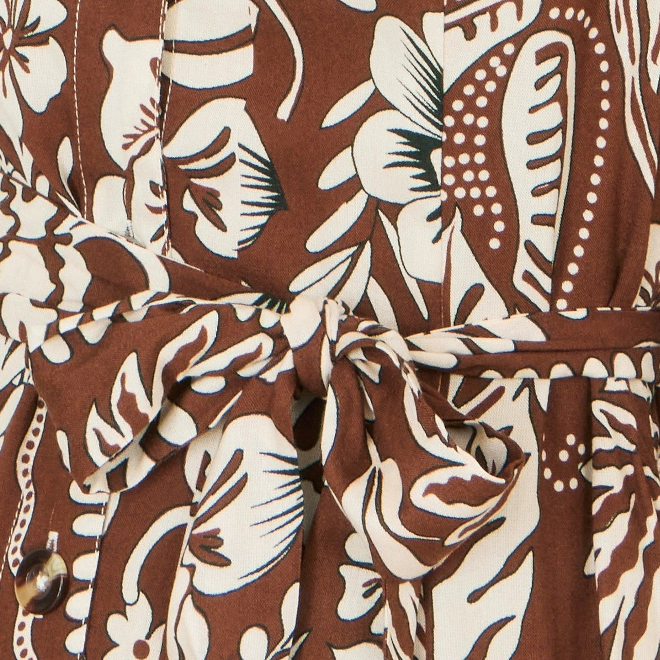 Brown dress with white floral pattern on a brown background