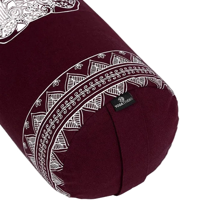 Maroon yoga bolster with white patterns on a white background