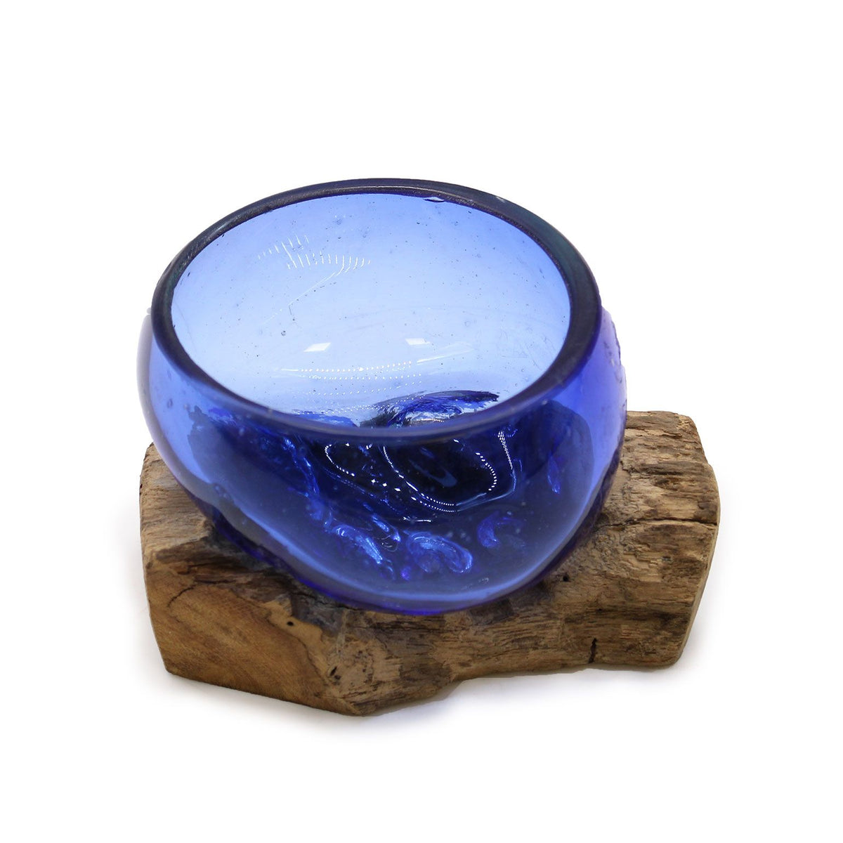 Angled view of a deep blue glass bowl on a natural wood base