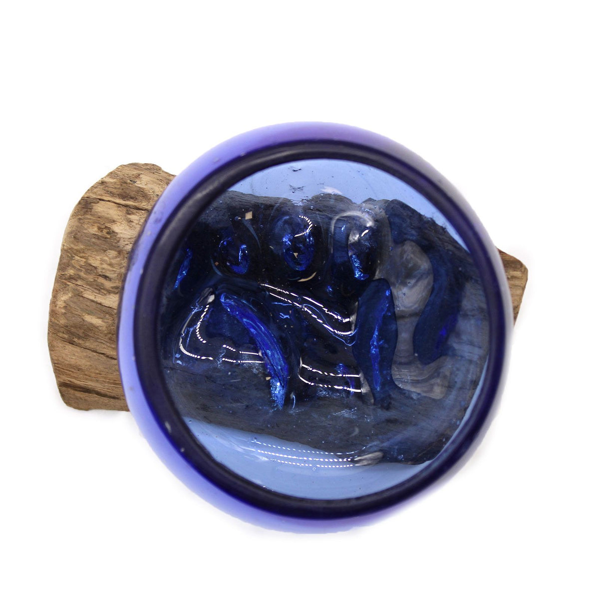 Overhead view into a deep blue glass bowl fitted around the contours of its wooden base
