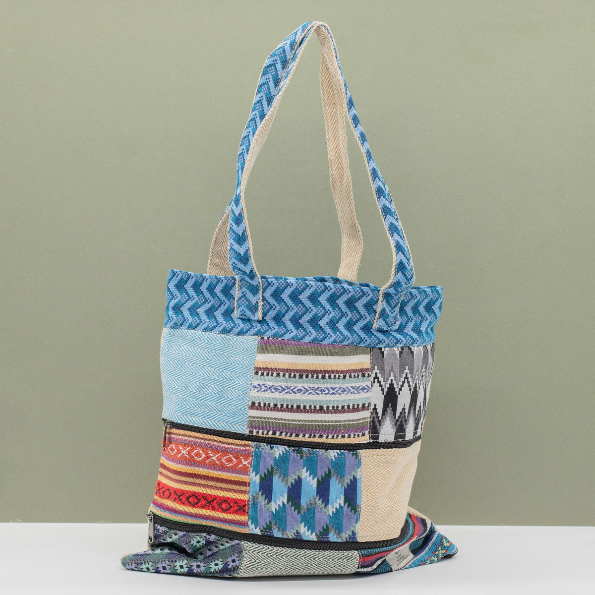 Multicoloured patterned tote bag on a light green background