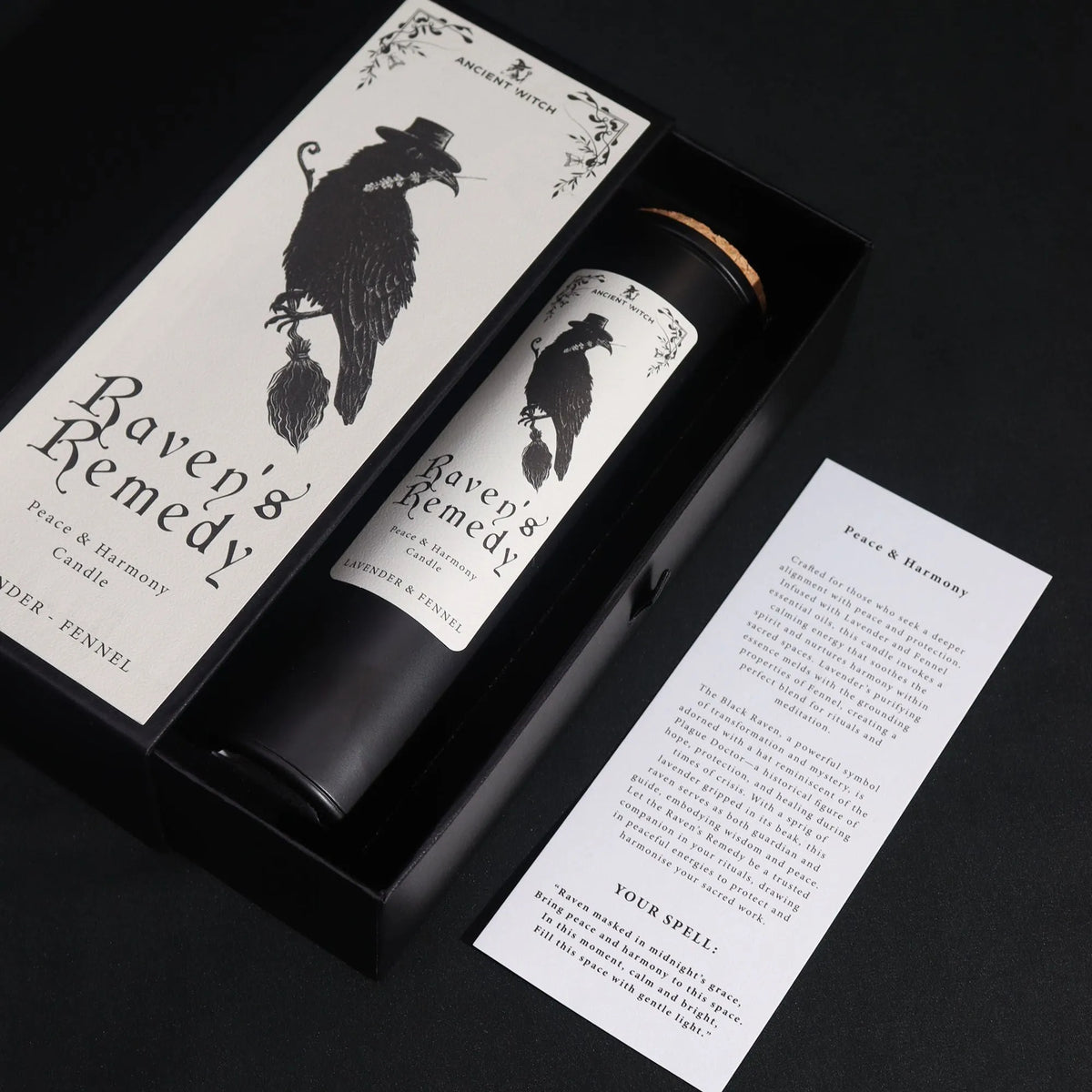 Raven’s Remedy candle and illustrated gift box with ritual spell card on a black background