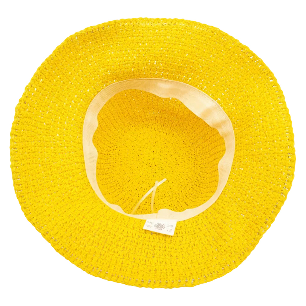 Yellow floppy straw hat with a white label on a white background