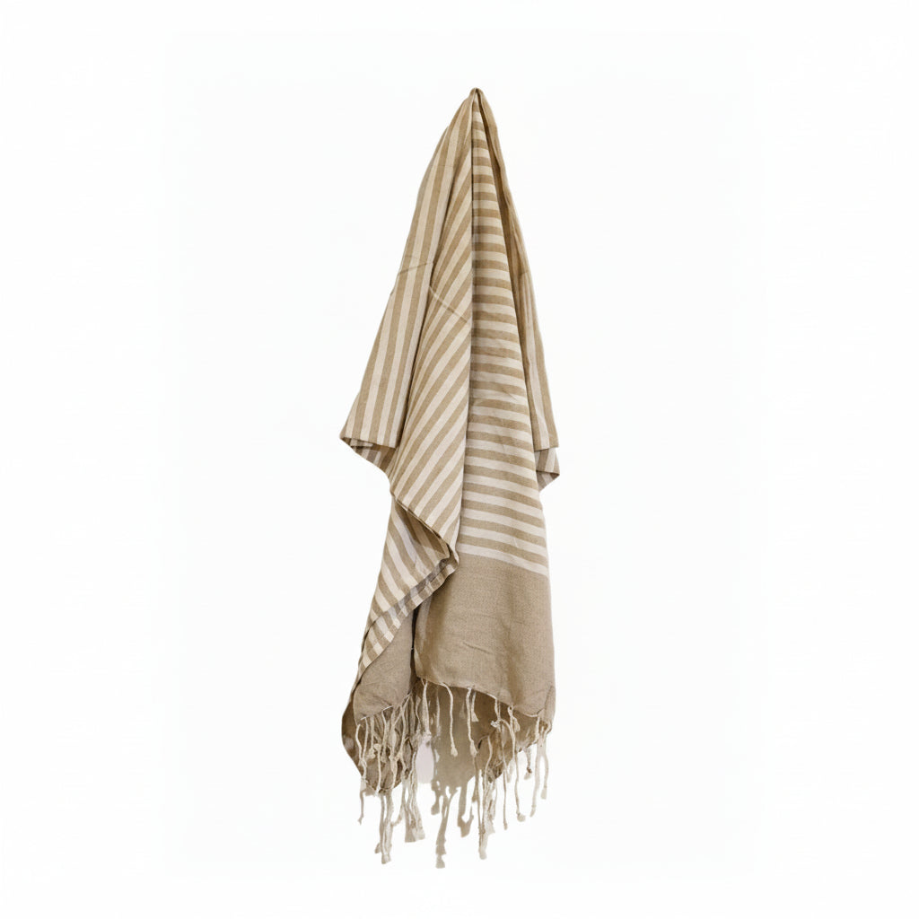 Beige and white striped towel with fringes on a white background