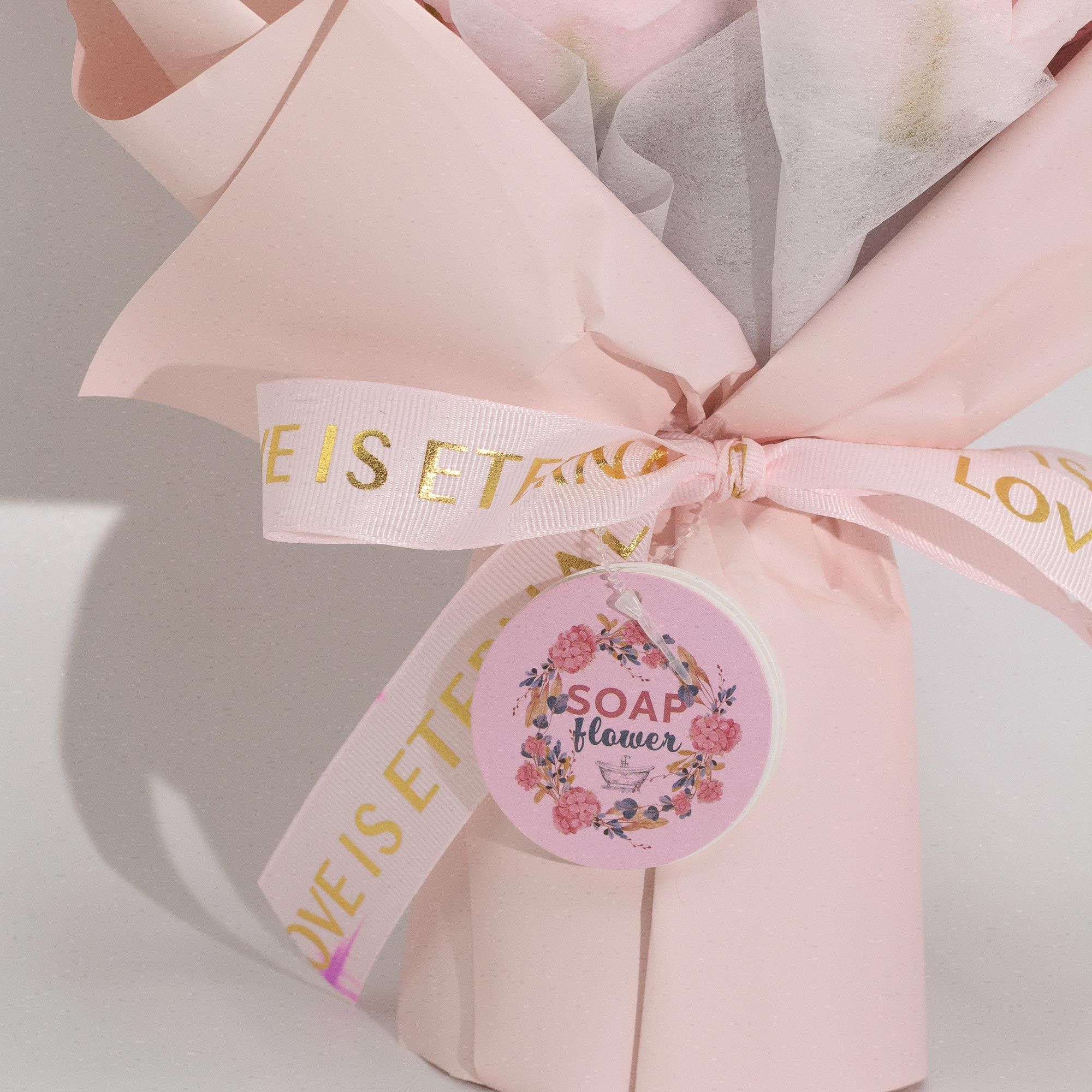 Pink soap flowers with a decorative bow and 'Soap & Flower' label on a light background