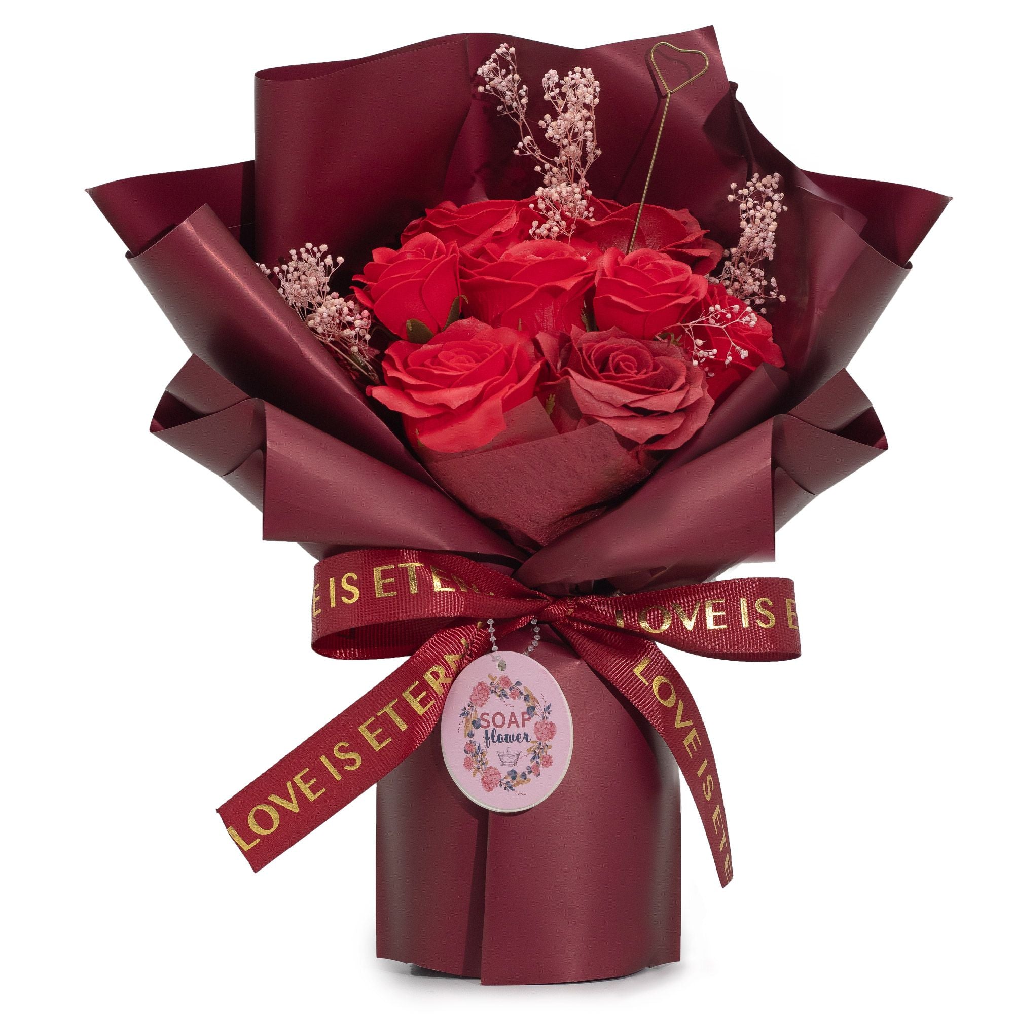 Bouquet of red rose soap wrapped in burgundy paper with a gold ribbon on a white background