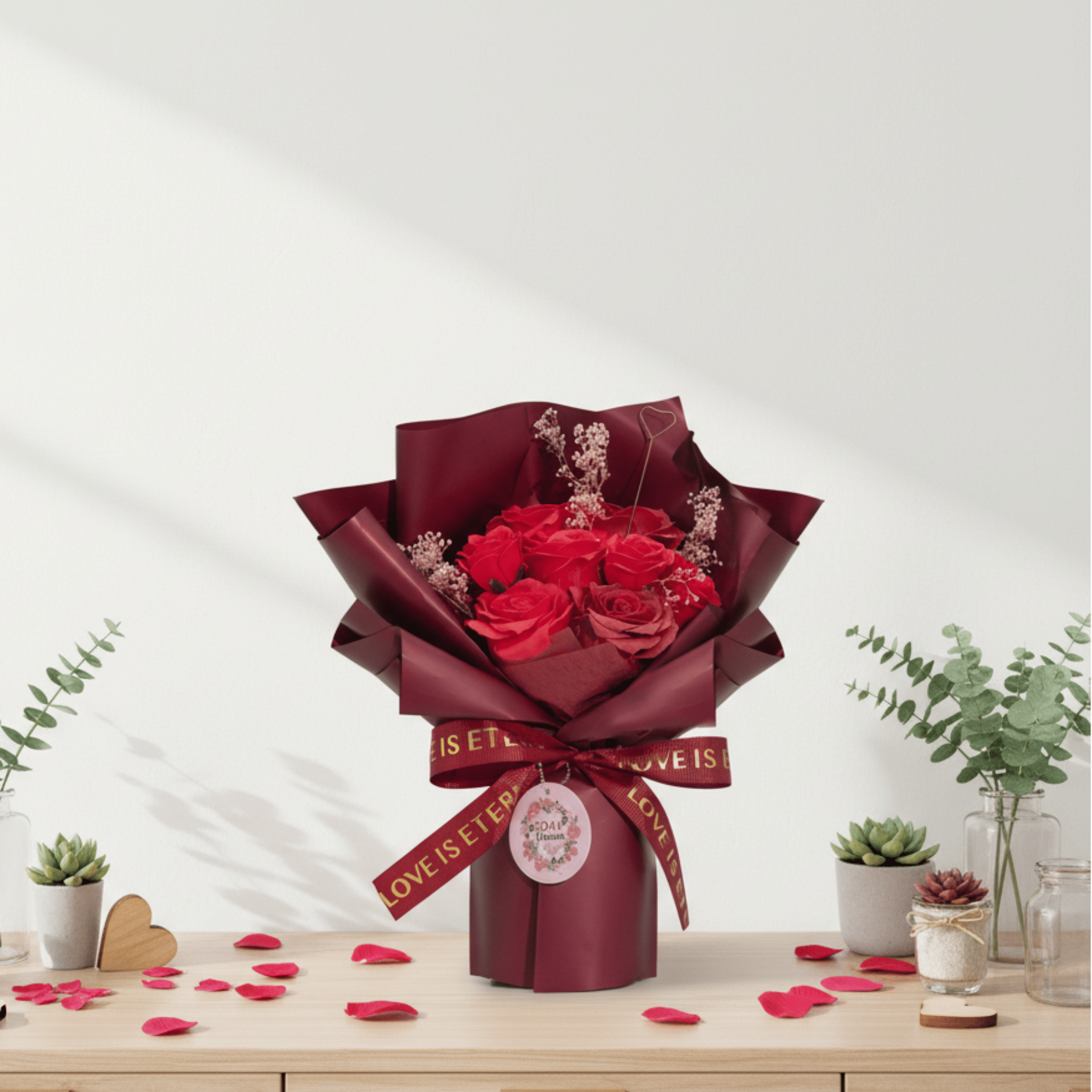 Bouquet of red rose soap wrapped in burgundy paper with a ribbon on a light wooden table.