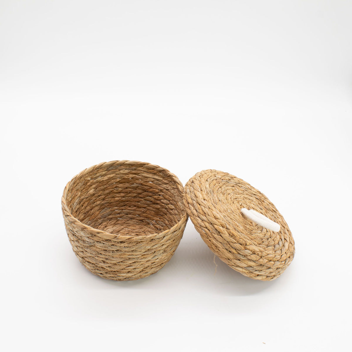 Small round woven basket with its matching lid beside it