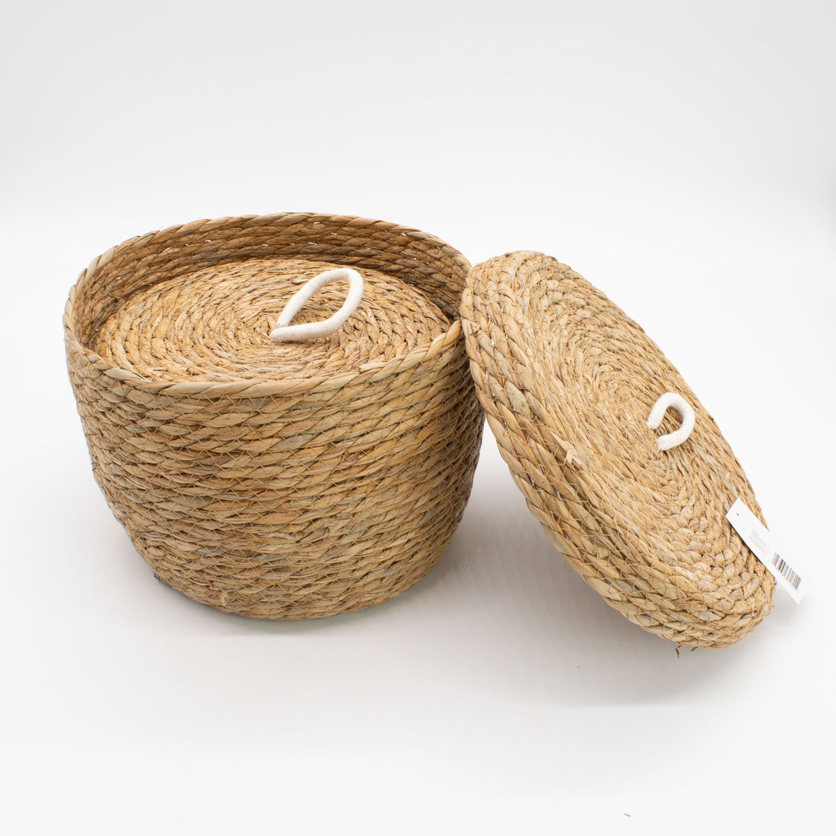 Smaller lidded basket nested inside a larger basket, with the outer lid leaning beside it