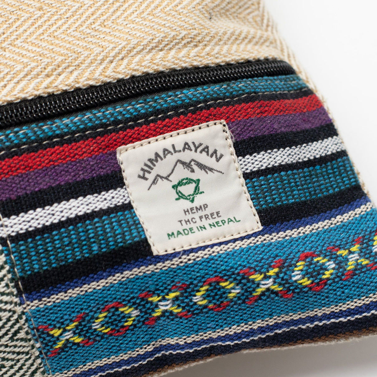 Close-up of the Himalayan Hemp Made in Nepal label on a striped patchwork panel