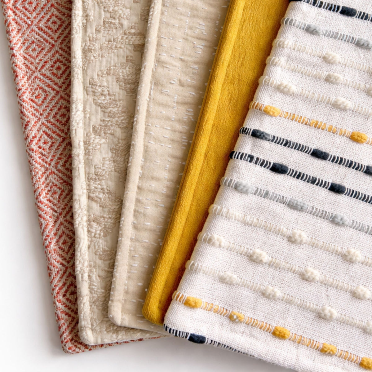 Four different textured cushion covers  on a white background
