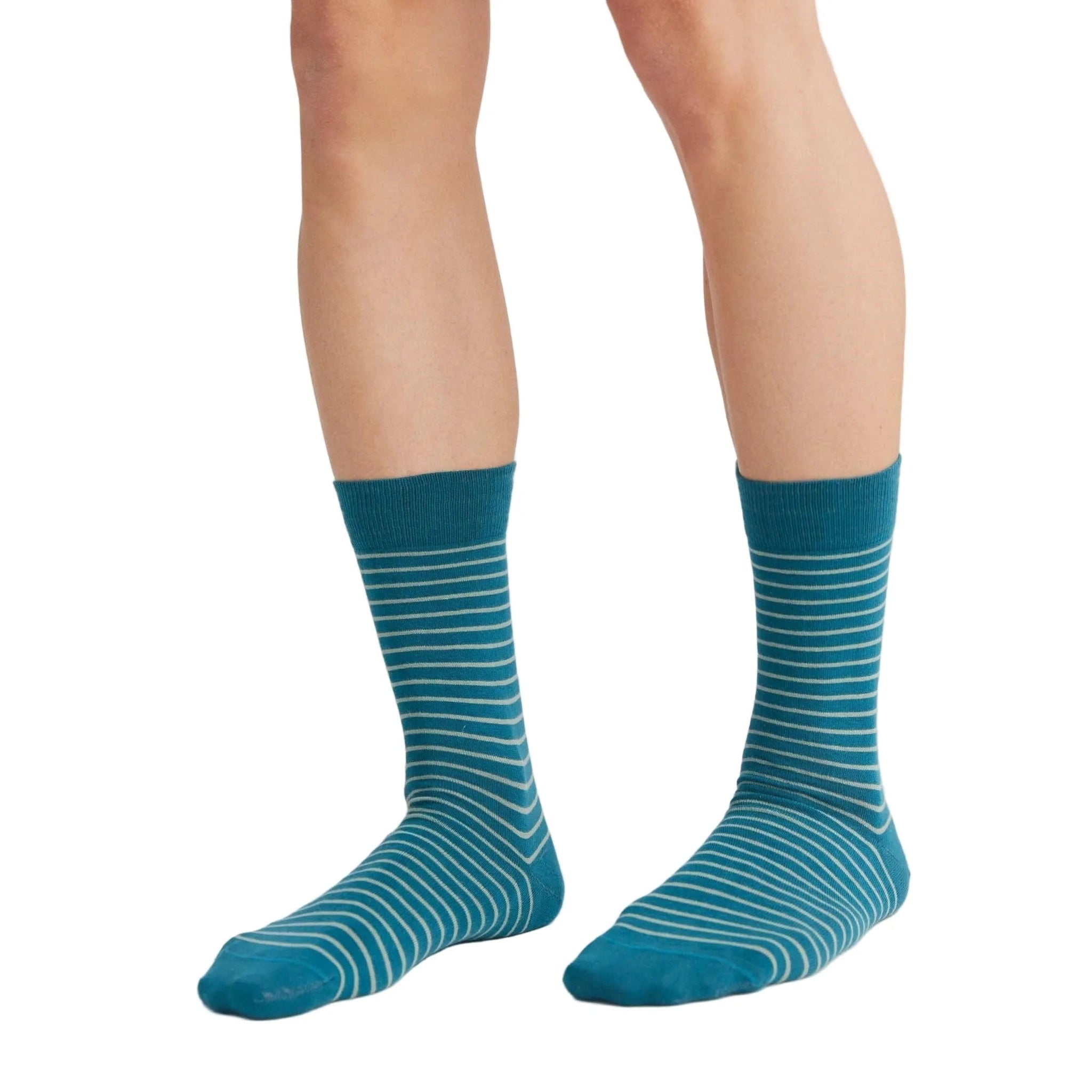 Teal striped socks worn by a person on a white background