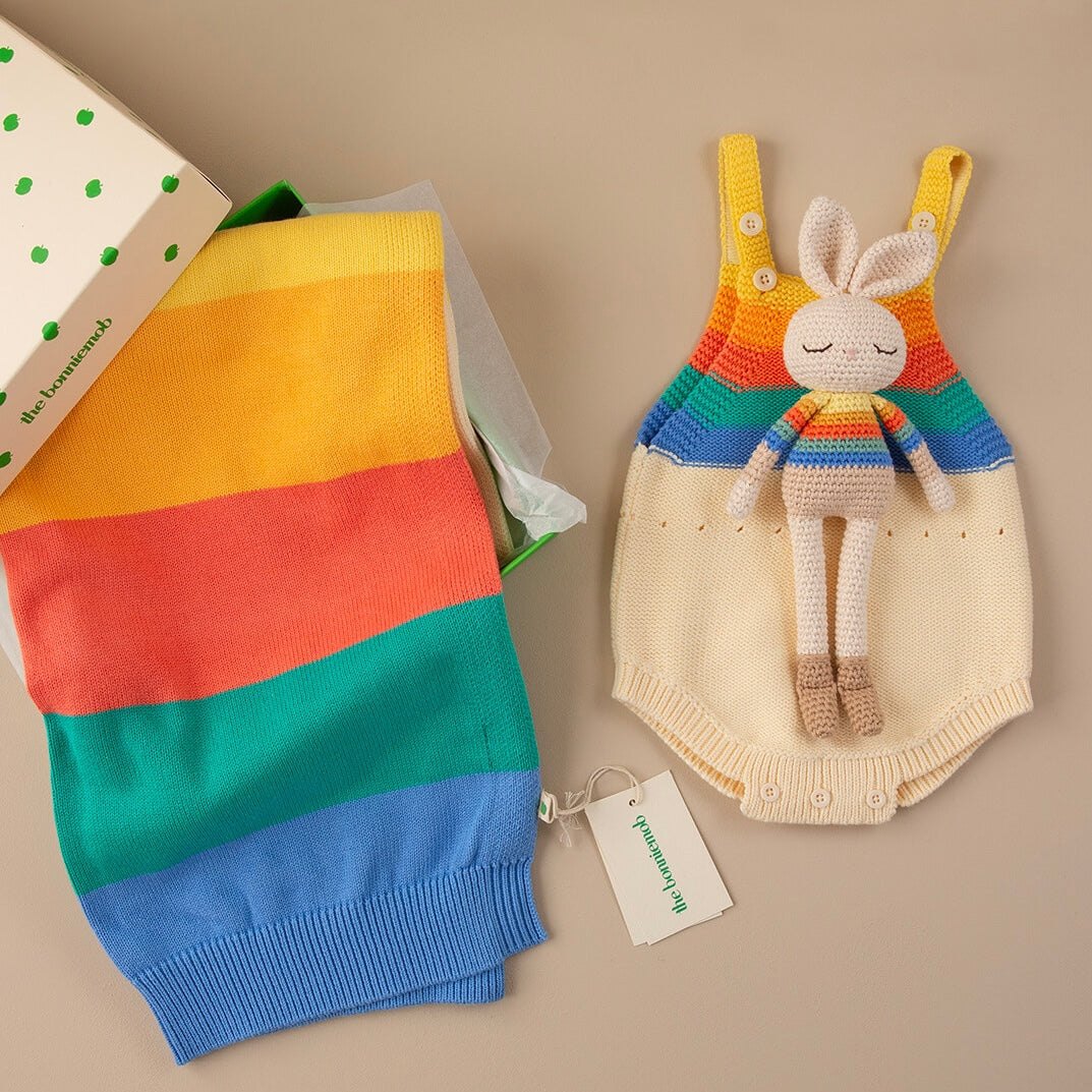Bonnie Bunny displayed with coordinating rainbow babywear, folded knitwear and branded box.