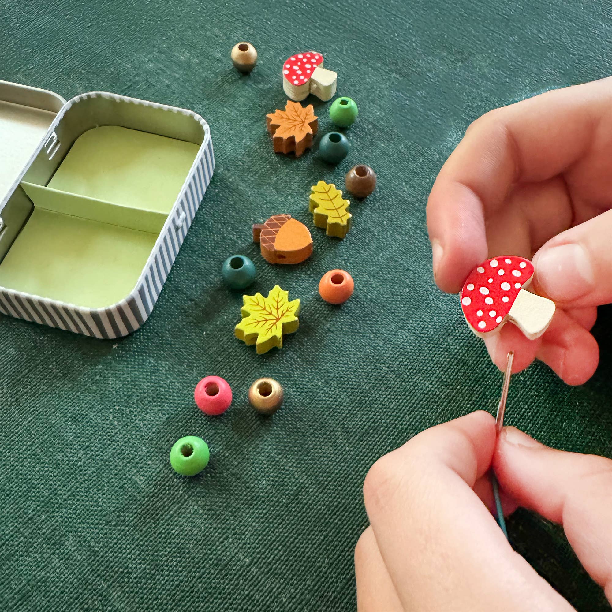 Forest-themed bracelet kit with open tin, bracelet, and packaging.