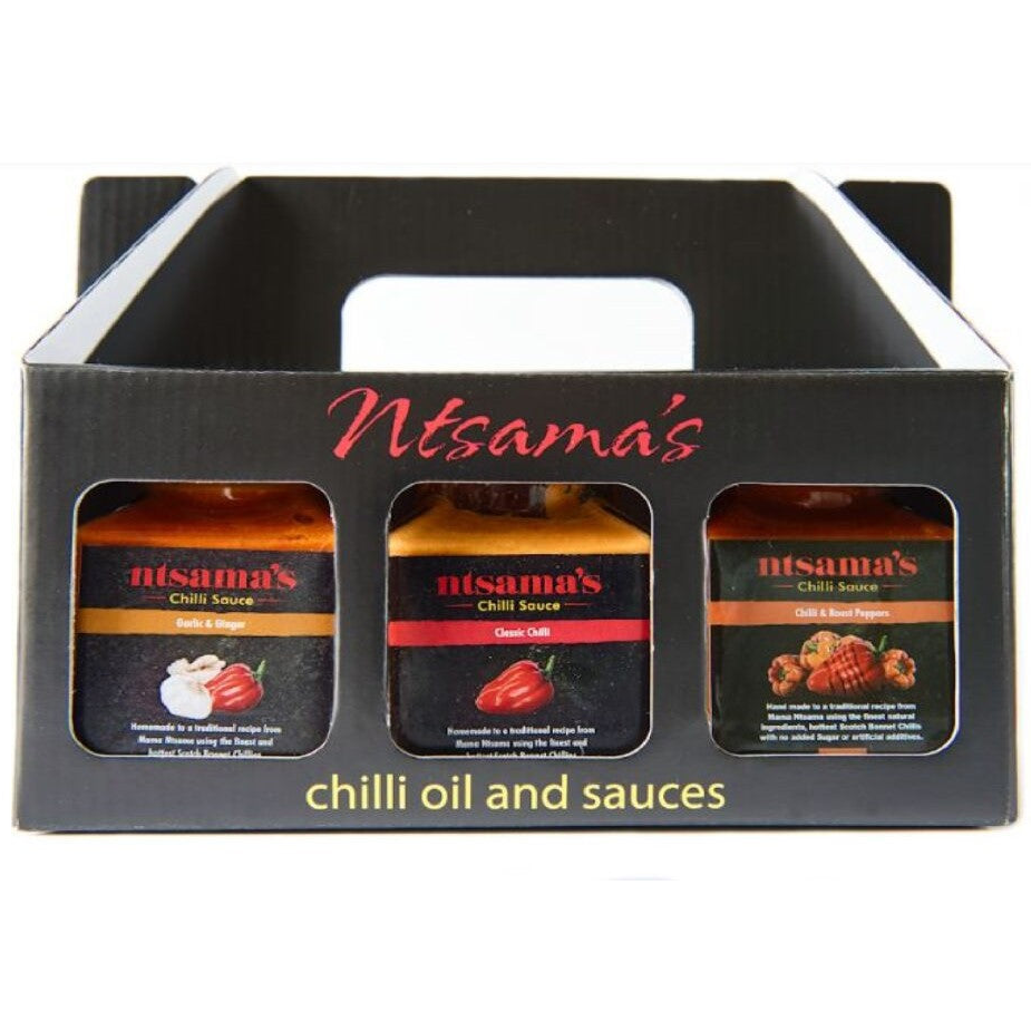 Ntsama's Chilli Sauces gift set in a black cardboard carrier with a handle, containing three jars of different chilli sauces.
